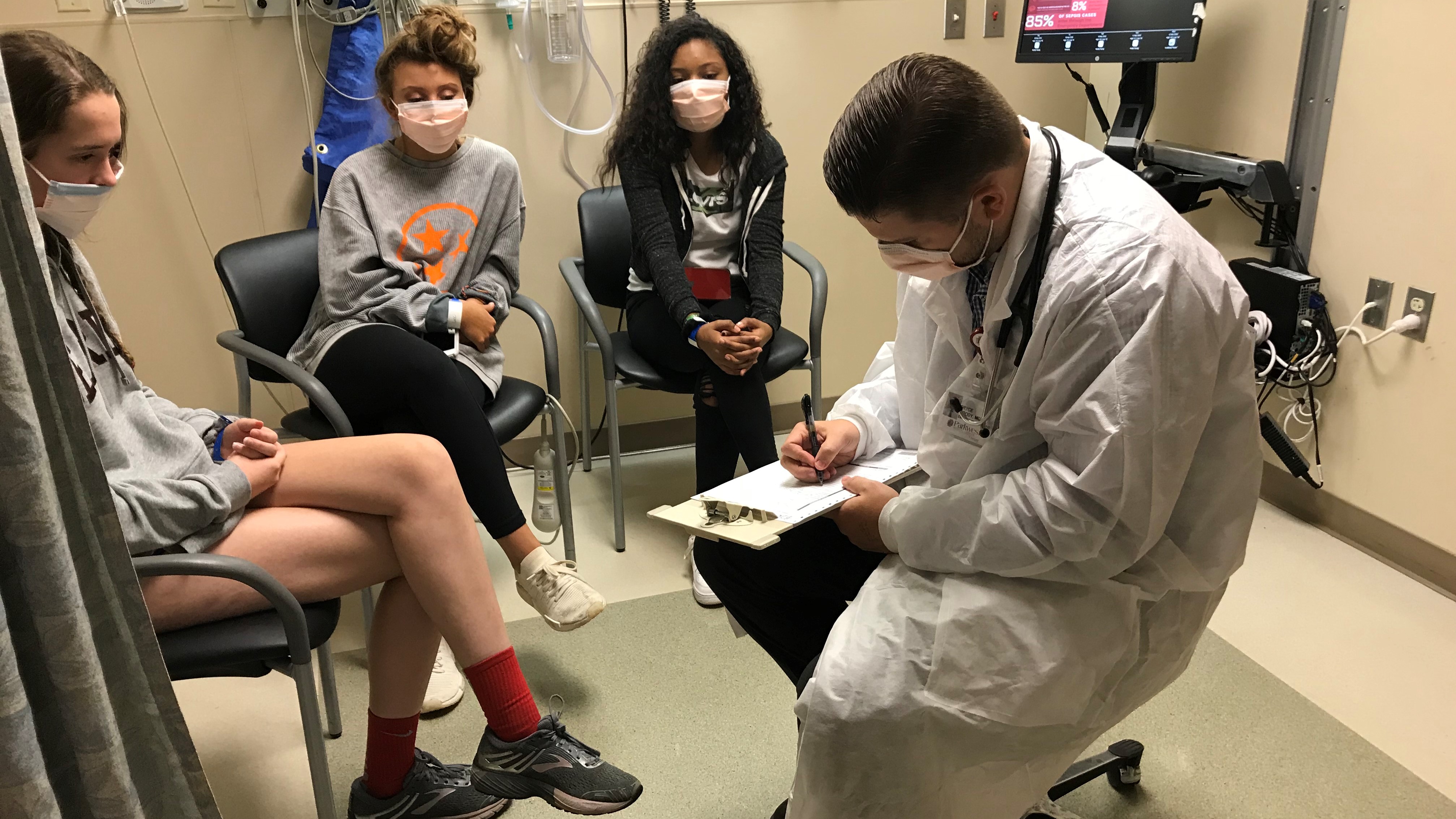 From left, Bearden High School students Maddie Brillhart, Gracie Sapp and Marissa Anderson speak with Parkwest Medical Center physician Bryce Moody during a disaster drill at the hospital. 